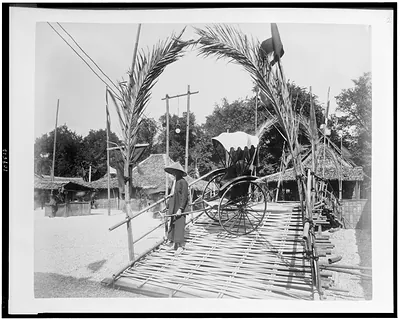 [Man posed with pousse-pousse in Tonkin Village, Paris Exposition, 1889]