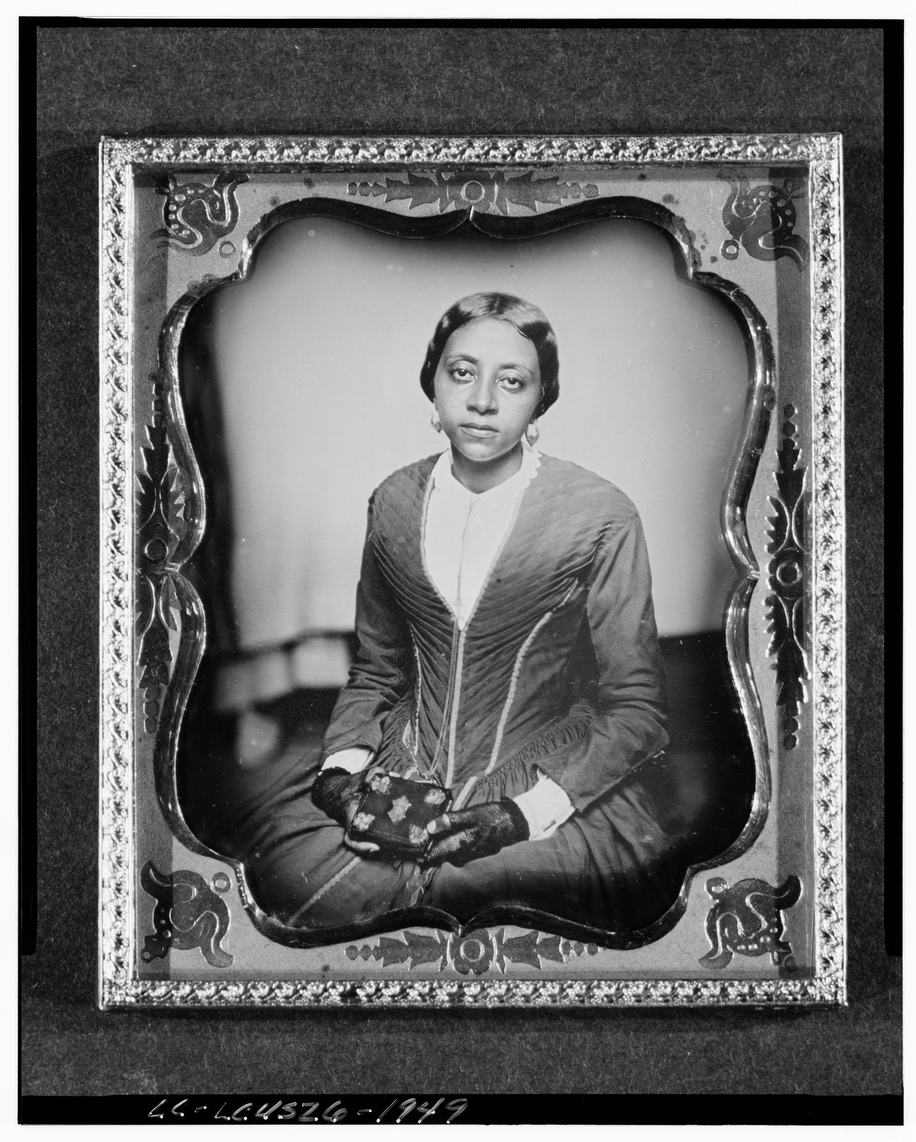 [Unidentified woman, probably a member of the Urias McGill family, three-quarter length portrait, facing front, holding daguerreotype case], [1855] — historic photograph