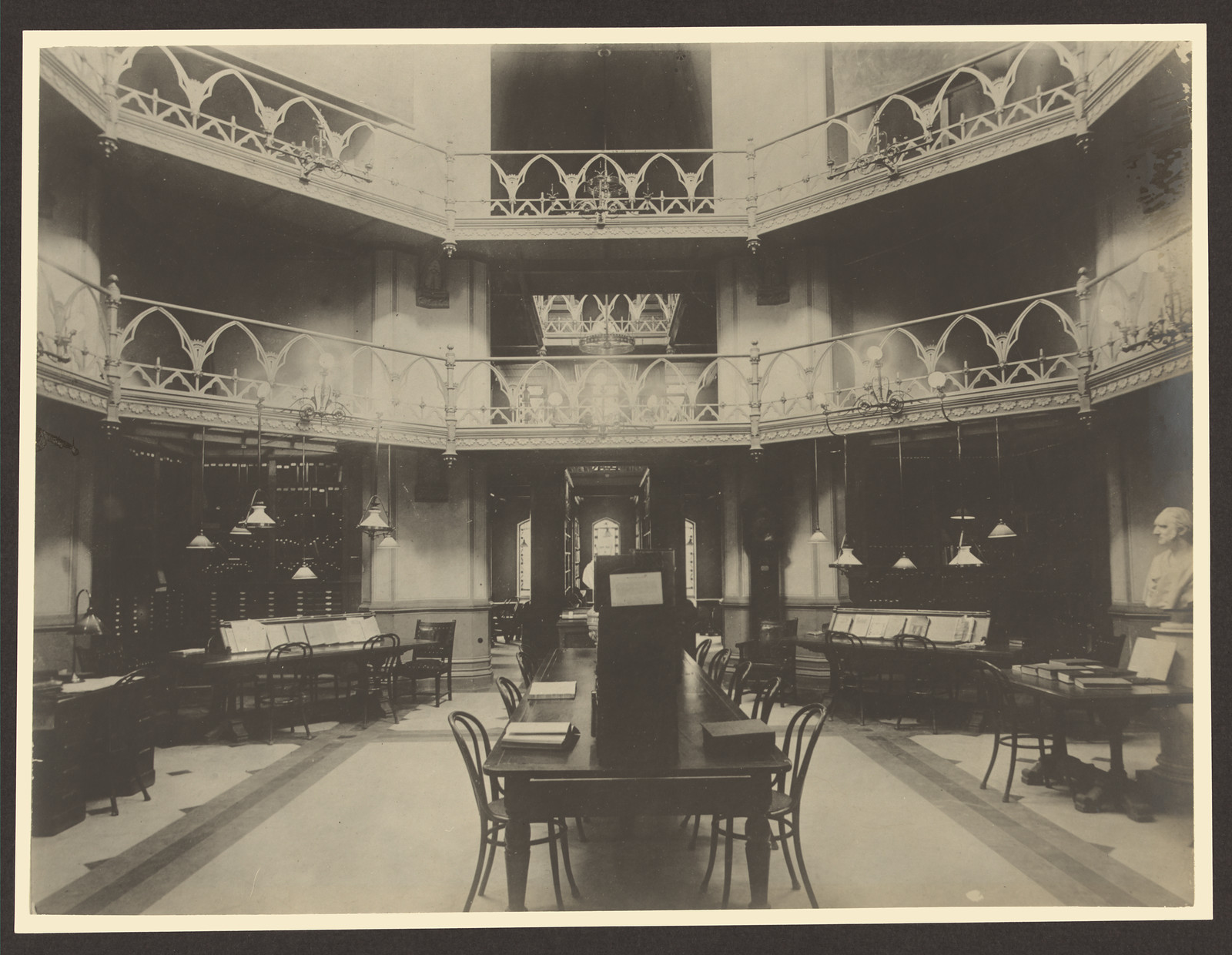 Library reading room with galleried balconies and long tables — historic image