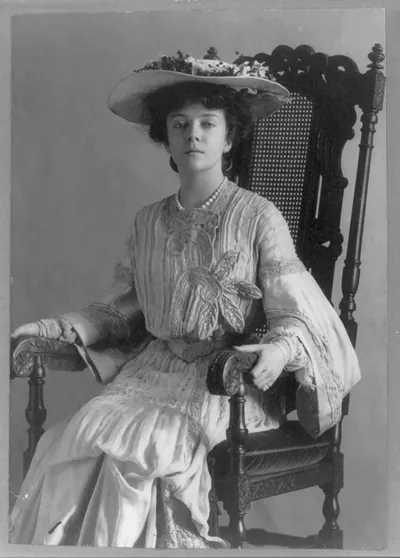 [Alice (Roosevelt) Longworth, 1884- , three-quarter-length portrait, seated in chair, facing left]