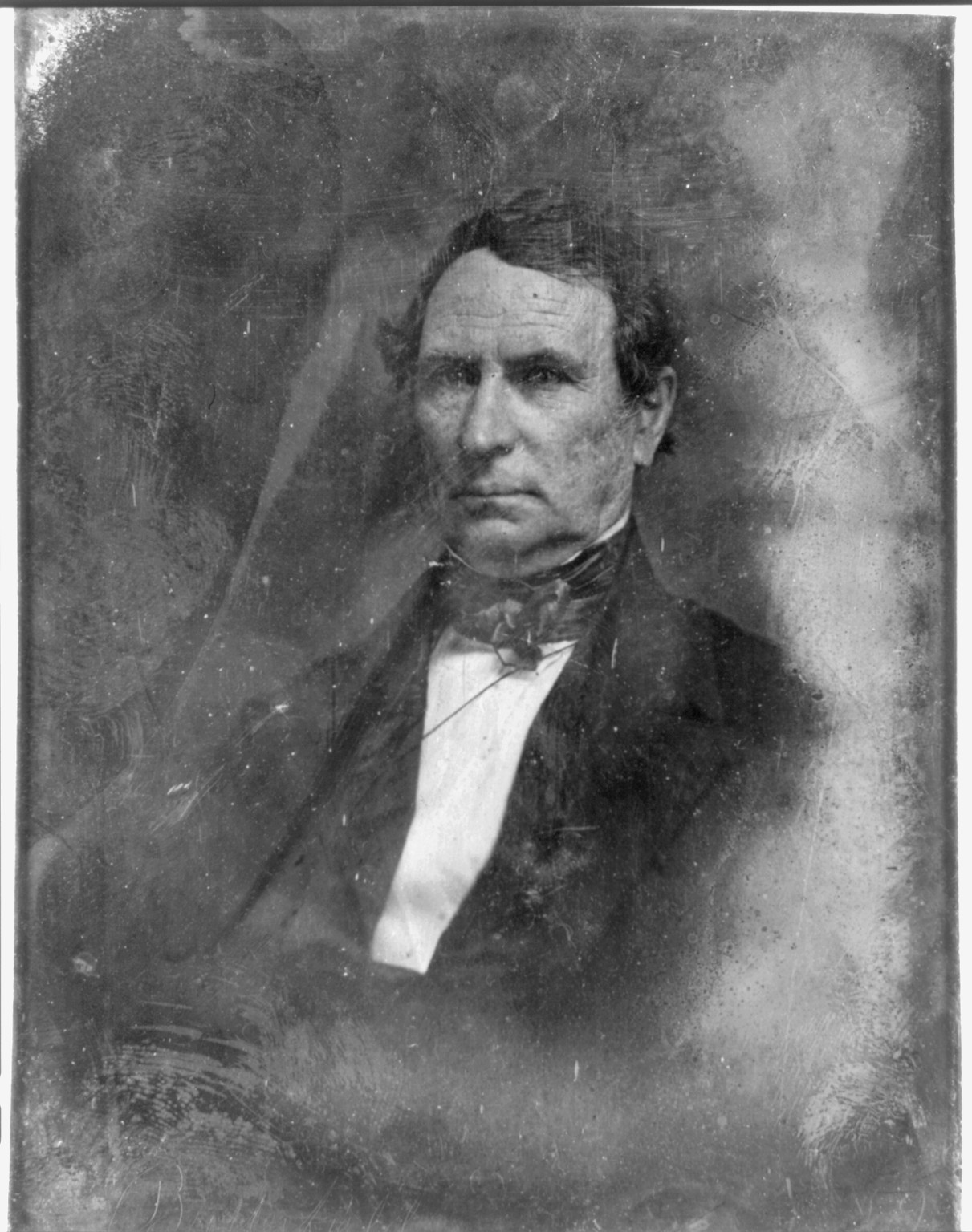 Daguerreotype portrait of a man in dark coat and bow tie, 1844 — historic photograph