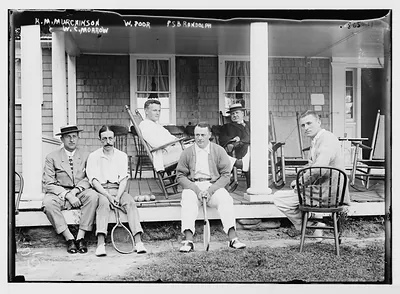 K.M. Murchinson, W.C. Morrow, W. Poor, P.S.B. Randolph, sitting on porch, with tennis racquets
