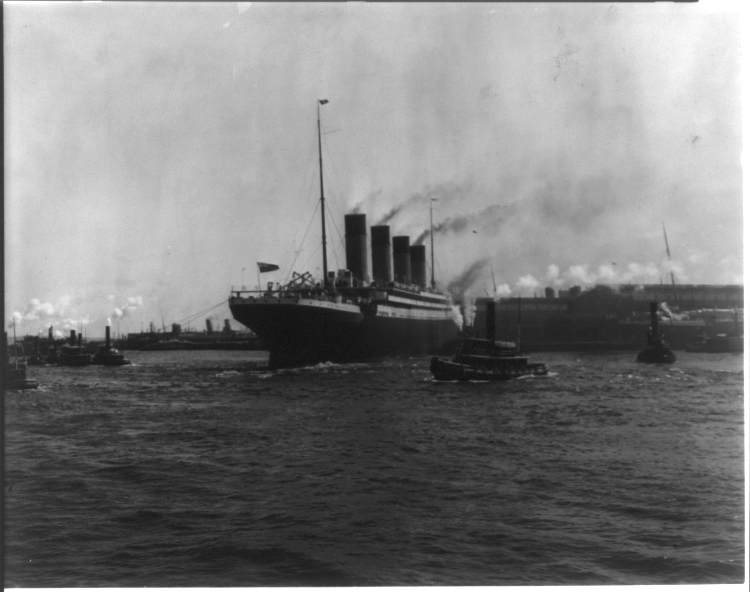 [The S.S. OLYMPIC, 1911: Tugs maneuvering ship into pier, New York Harbor], c1911. — historic photograph