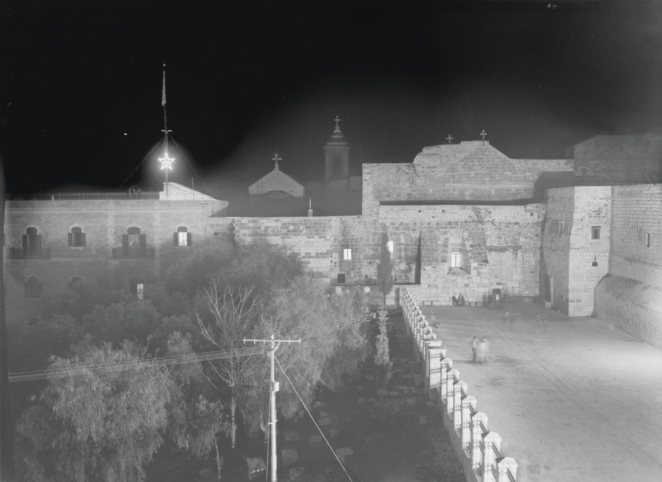 Church complex at night with illuminated star — historic image