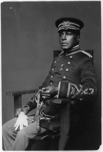 [Charles Young, full-length portrait, seated, facing left, in military dress uniform]