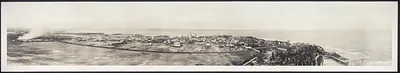 Panoramic photograph of a coastal town with harbor