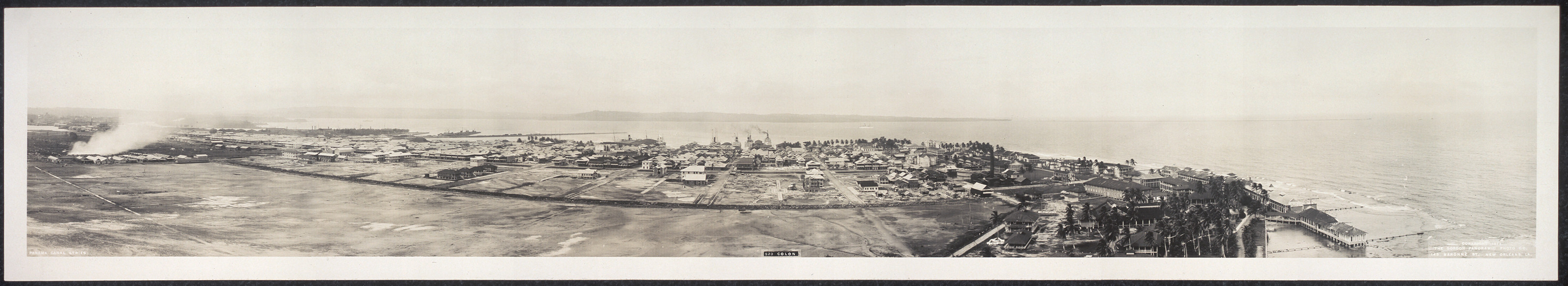 Panoramic photograph of a coastal town with harbor — historic photograph