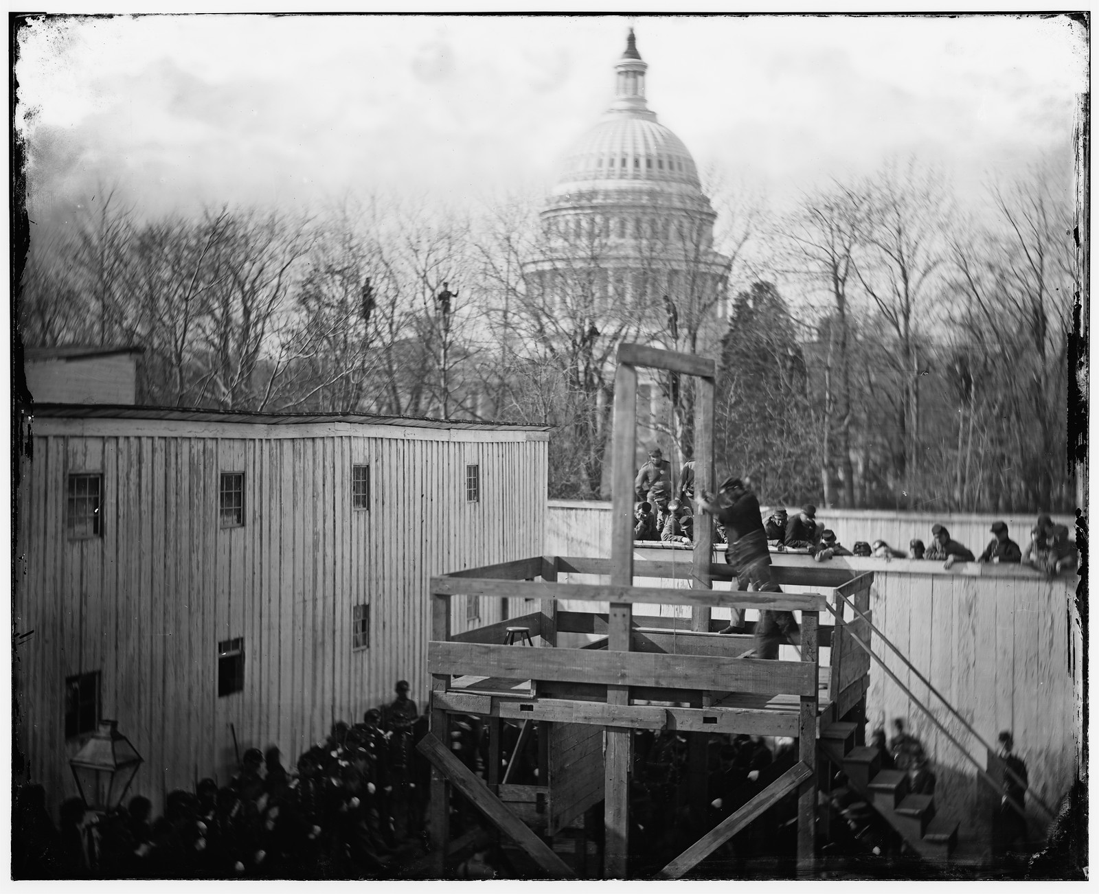 Washington D.C. Soldier springing the trap; men in trees and Capitol dome beyond, 1865 — historic photograph