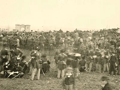 Crowd of Civil War soldiers and officers before a stone gateway