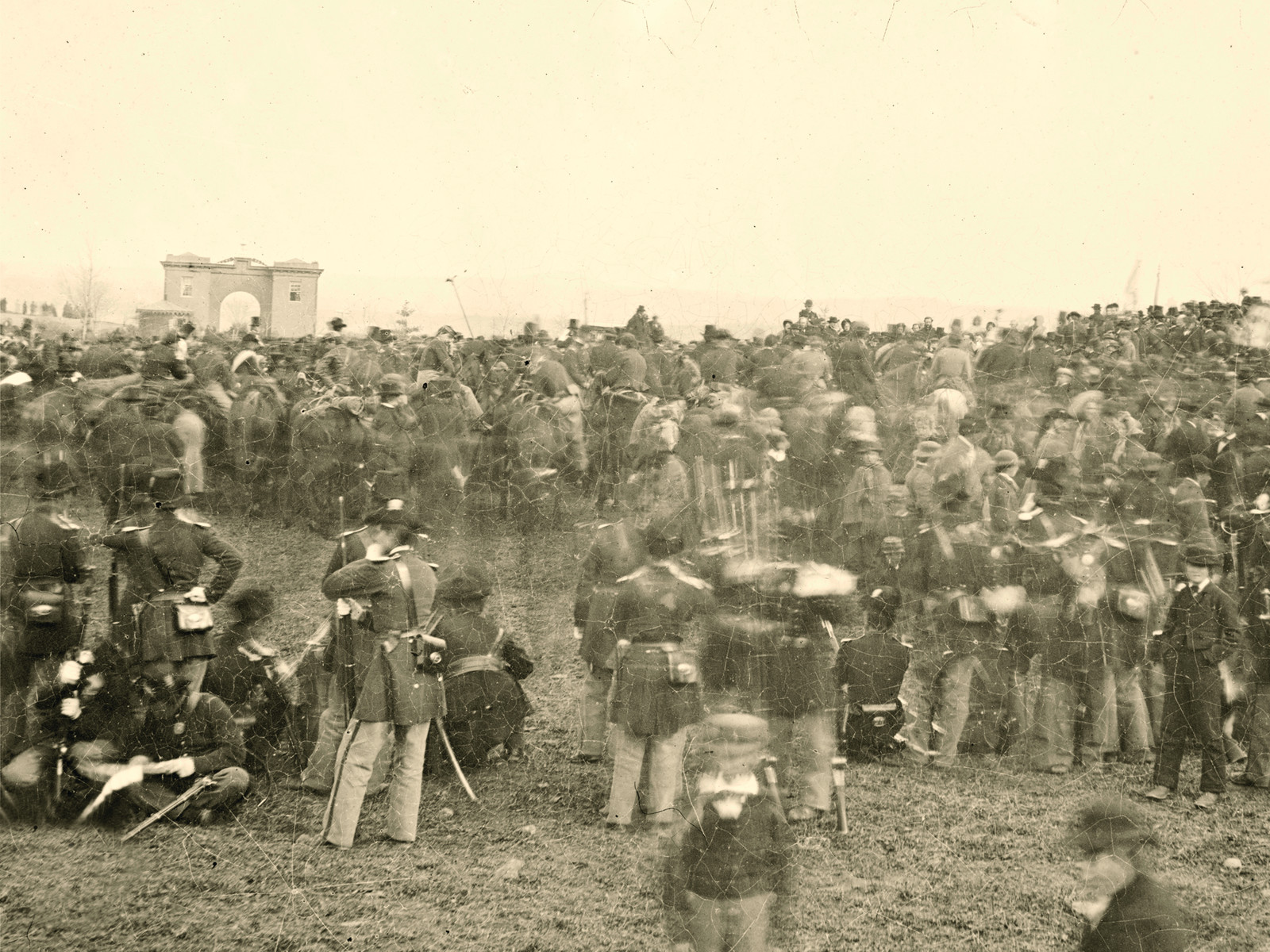 Crowd of Civil War soldiers and officers before a stone gateway — historic image