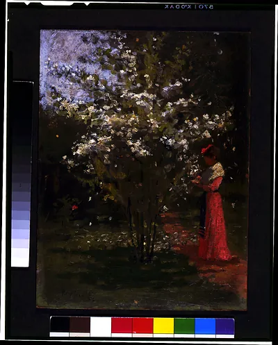 [Woman standing by flowering tree] / Percy Ives.