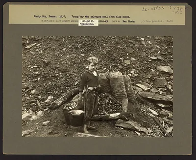 Young boy who salvages coal from slag heaps