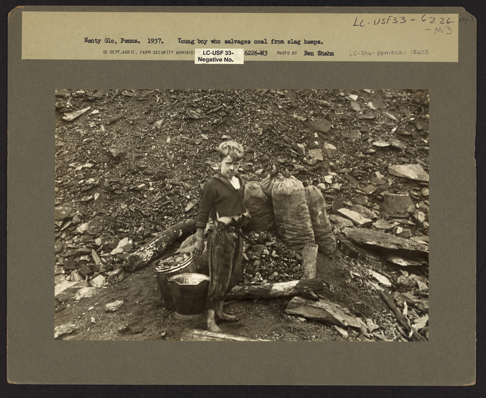 Young boy who salvages coal from slag heaps — historic image