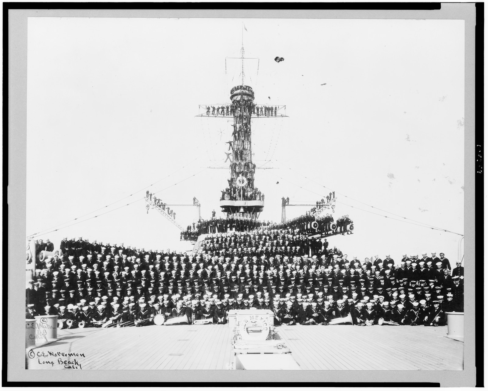 [Crew of the U.S.S. New Mexico posed on deck, on large guns, etc.], c1920. — historic photograph