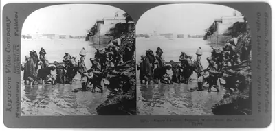 Water carriers dipping water form the Nile River, Egypt