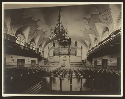 Concert hall interior with pipe organ and chandelier