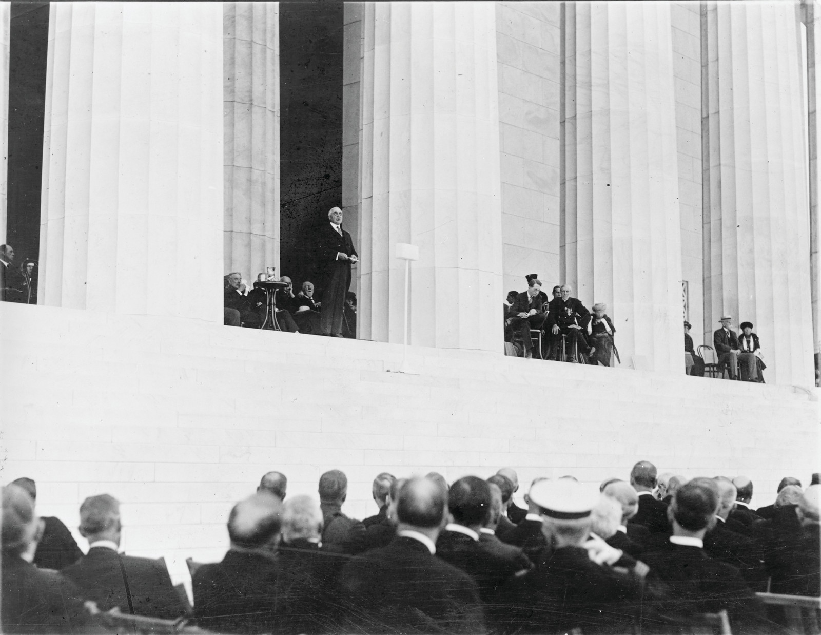 Speaker addressing seated dignitaries and audience at Lincoln Memorial — historic image