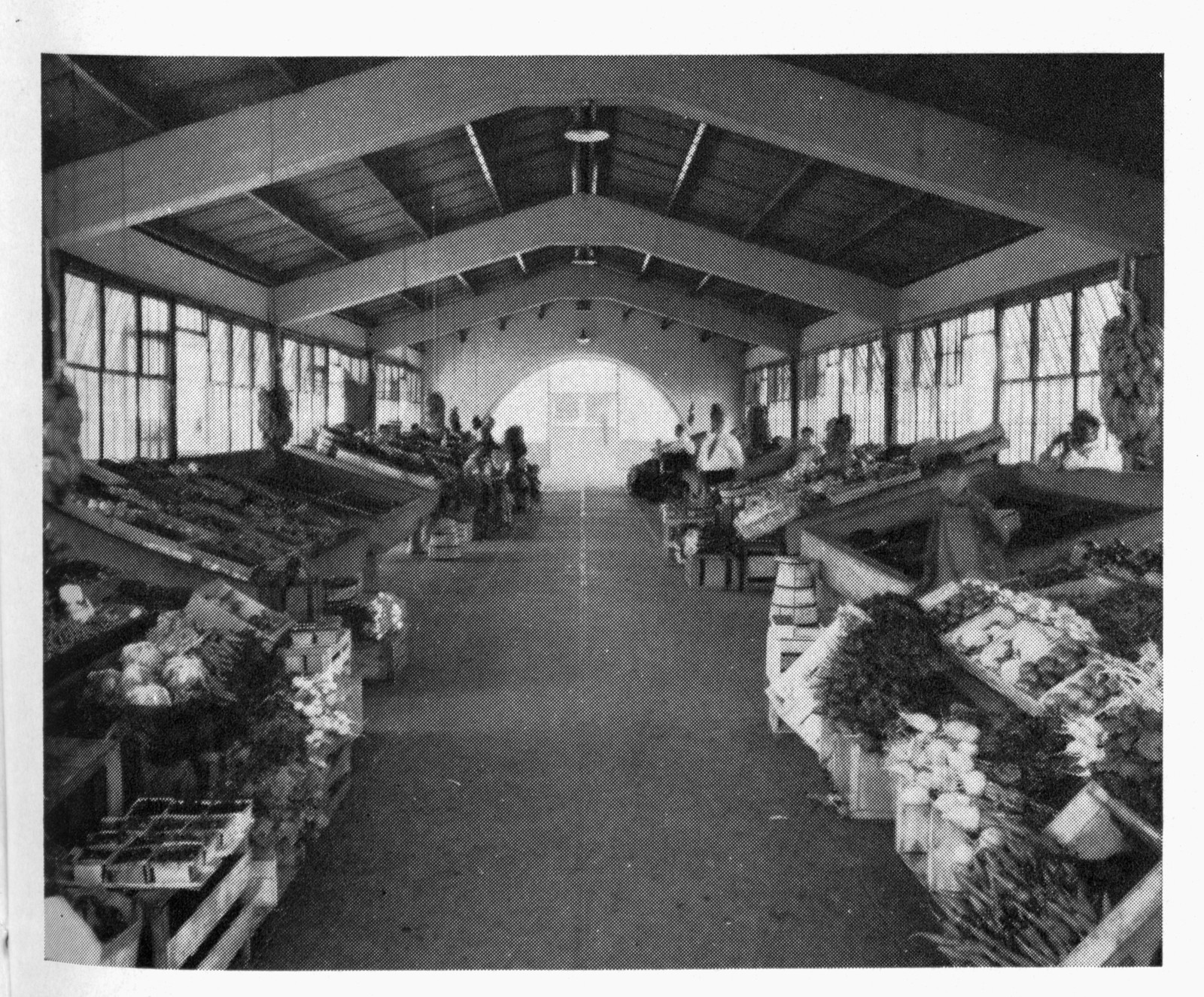 Covered produce market interior with crates and piled vegetables — historic image