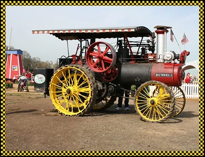 Antique Russell steam traction engine with yellow wheels
