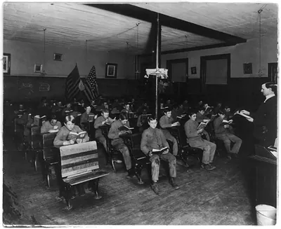 [Boys and teacher in classroom at the Golden Industrial School, Denver, Colorado(?)]