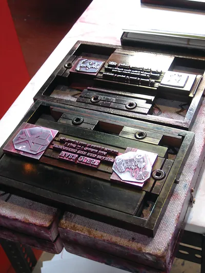 Metal letterpress type and blocks locked in a chase
