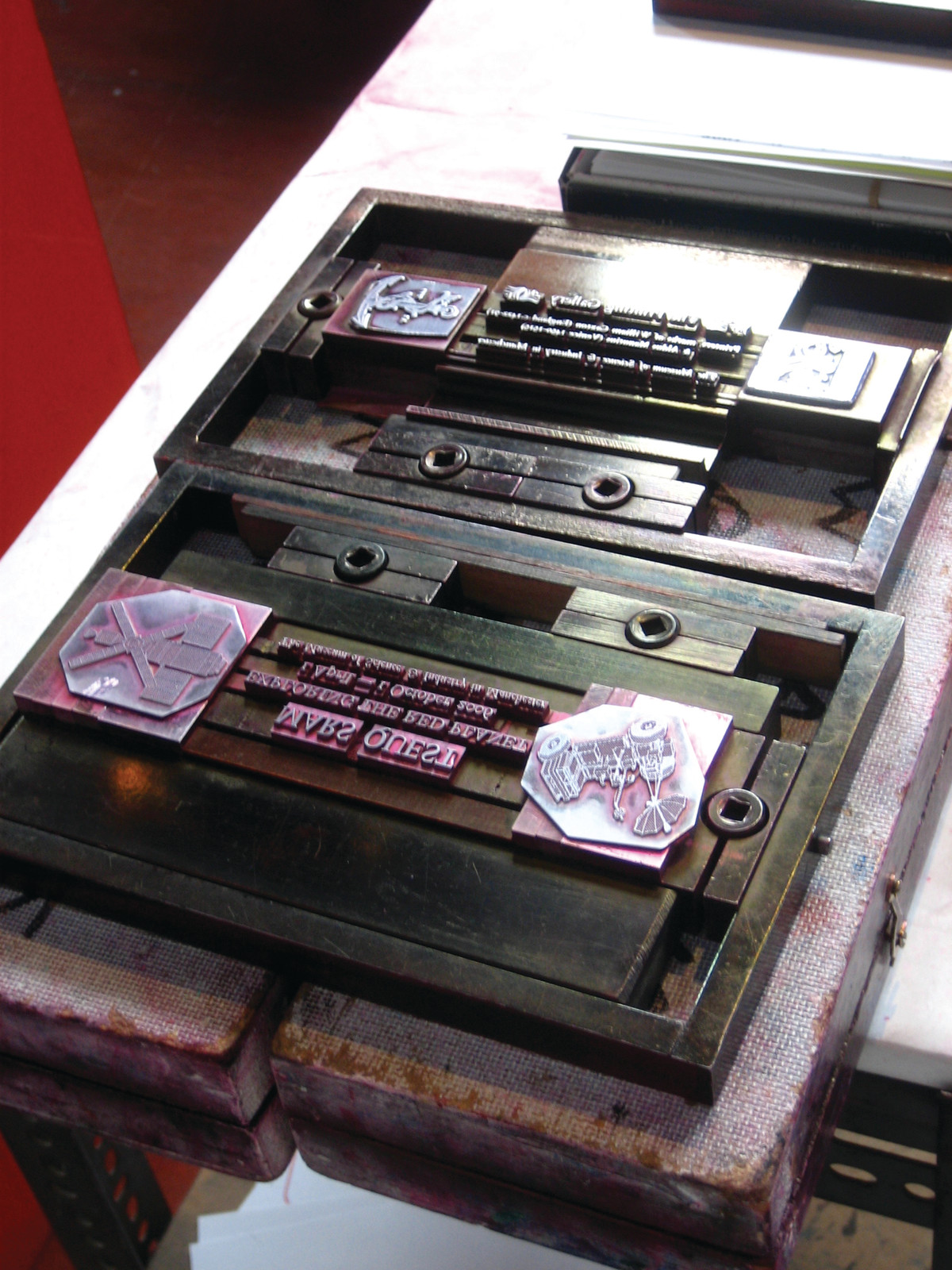 Metal letterpress type and blocks locked in a chase — historic image