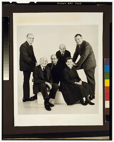 [Charles and Ray Eames, designers, in group portrait with Hugh De Pree, George Nelson, Alexander Girard, and another man at Walker Art Center opening in Minneapolis, MN]