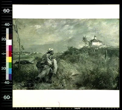 Man in white hat kneeling in grass before a white blockhouse