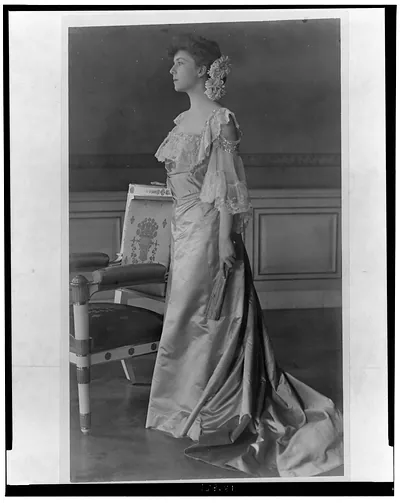 [Alice Roosevelt Longworth, full-length portrait, standing next to chair, facing left]
