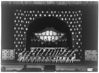 Pearly teeth and polka dot columns formed a backdrop for these road show chorus cuties at the Capitol Theatre in the 1930s