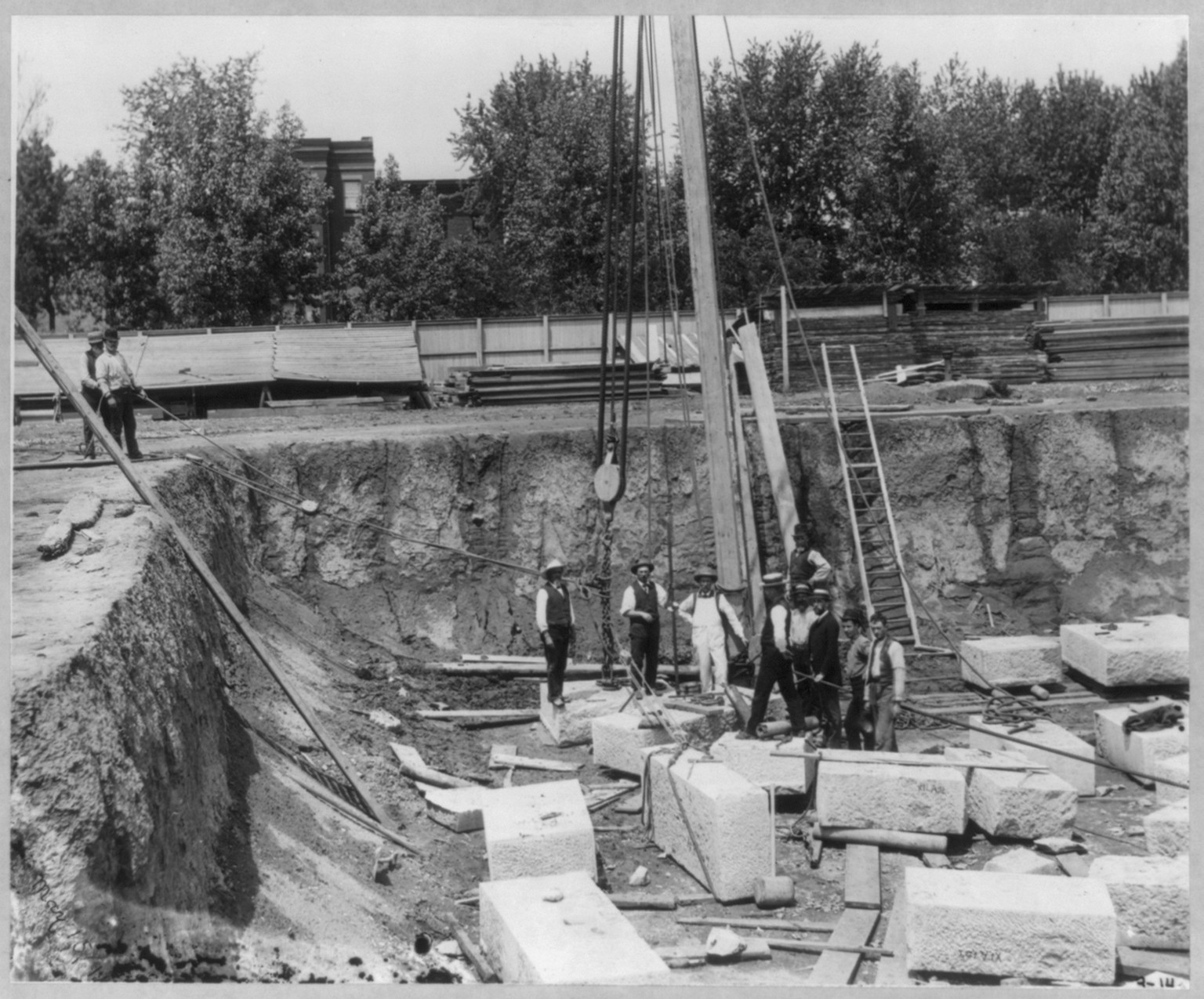 [Library of Congress foundation, 1889: view of corner of foundation, with men using block and tackle] — historic photograph