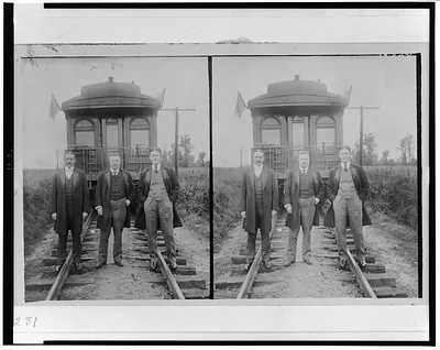 [Theodore Roosevelt, full-length portrait, standing, with two other men in front of railroad observation car]