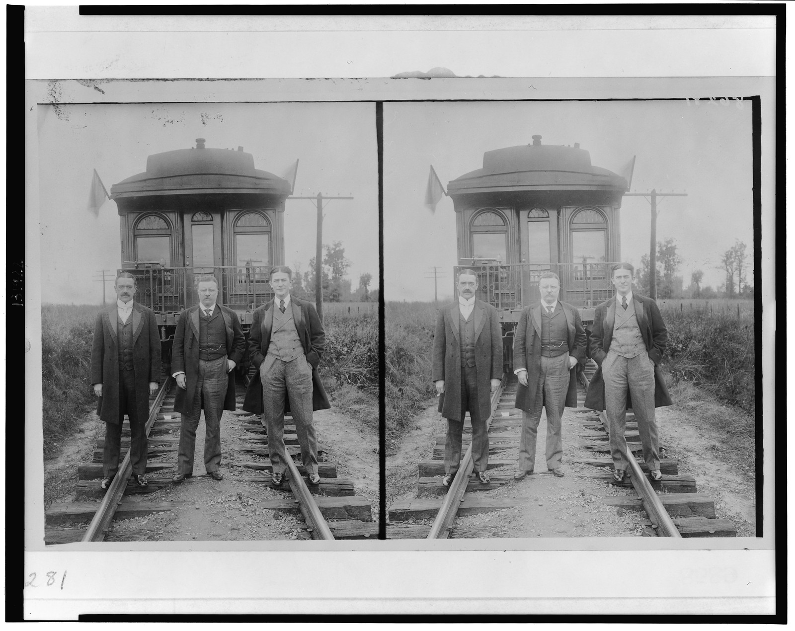 [Theodore Roosevelt, full-length portrait, standing, with two other men in front of railroad observation car], [1905] — historic photograph