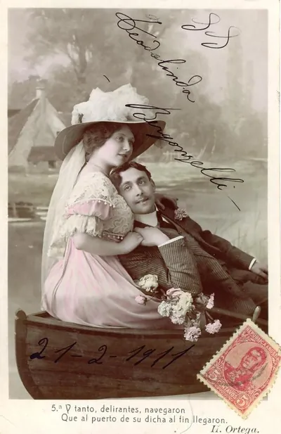 Hand-tinted postcard of a couple in a rowboat