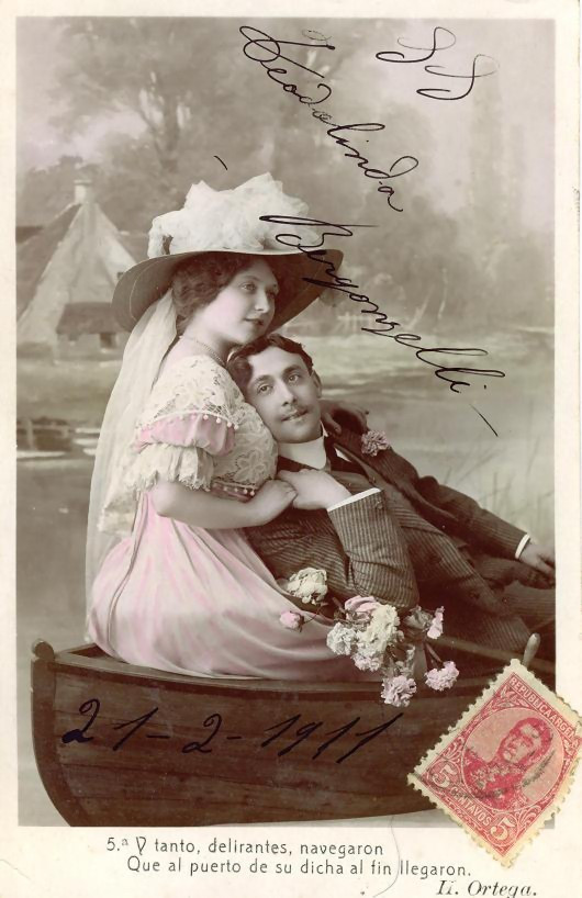 Hand-tinted postcard of a couple in a rowboat — vintage postcard