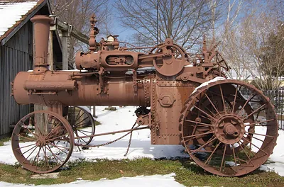 Rusted antique Case steam tractor in snow