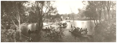 Boats and passengers on a park lagoon, sepia panorama