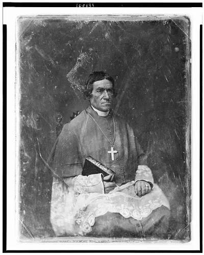 [Bishop Frederic Baraga, three-quarter length portrait, facing three-quarters to right, seated, in clerical robes, holding his Dictionary of the Otchipwe Language]