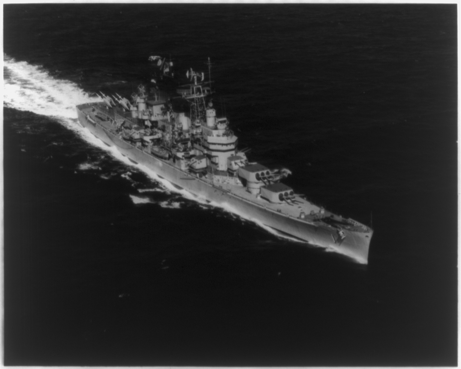 Starboard bow view of the USS BOSTON (CAG-1), the Navy's first guided missile cruiser, underway off Guantanamo Bay, Cuba, 1956 March 2. — historic photograph