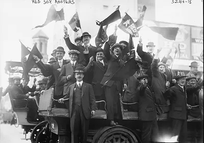 Red Sox rooters waving flags from an open vehicle