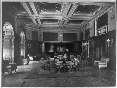 [Library of Congress. Congressional Reading Rooms: Three people at table with books in the Senate Reading Room]