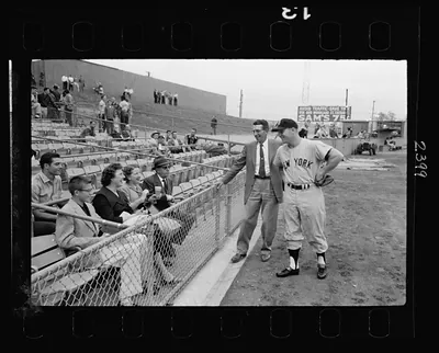 [Tom Greenwade, New York Yankee baseball scout, with Mickey Mantle and another Yankee player talking with fans at a ball park] / Jim Hansen.