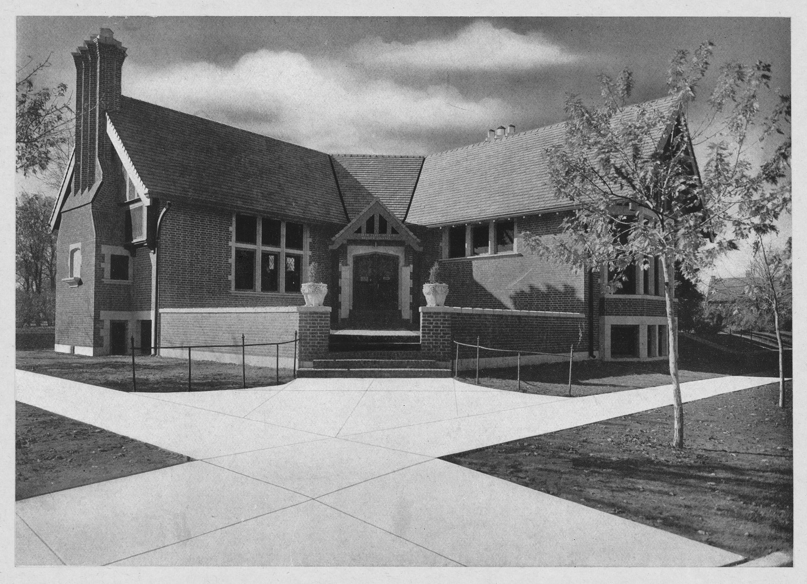 Brick Tudor-style branch building with gabled entrance and lawn — historic image
