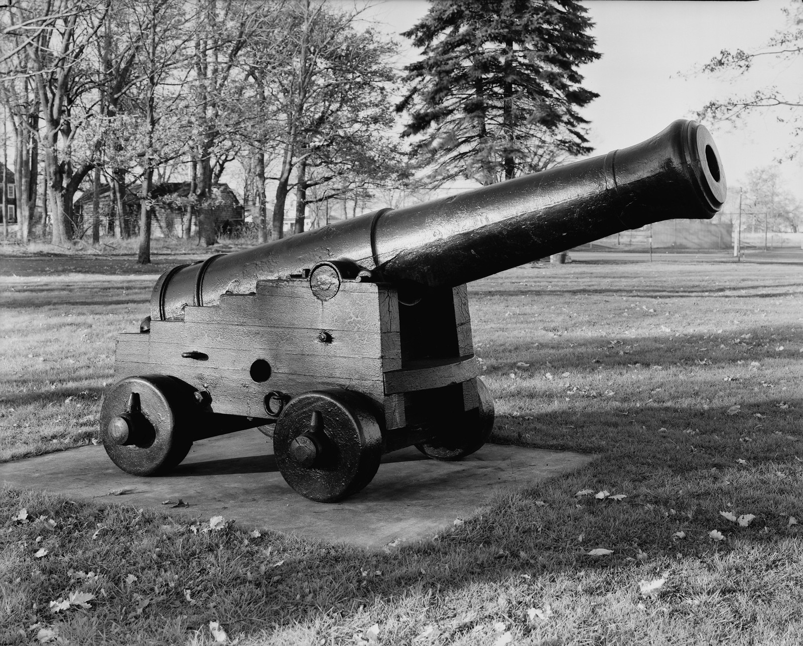 Black and white photo of a cannon on a wooden carriage — historic image