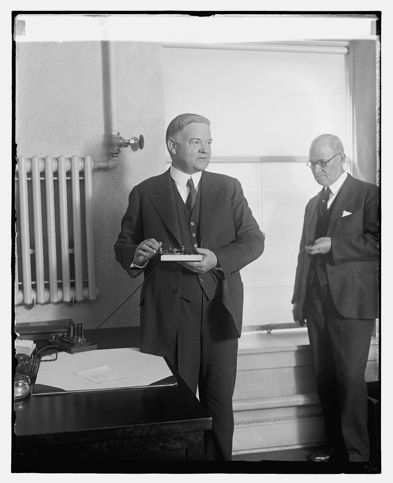 Hoover presses a button to start machinery in Detroit News, 12/6/29, [19]29 December 6. — historic photograph