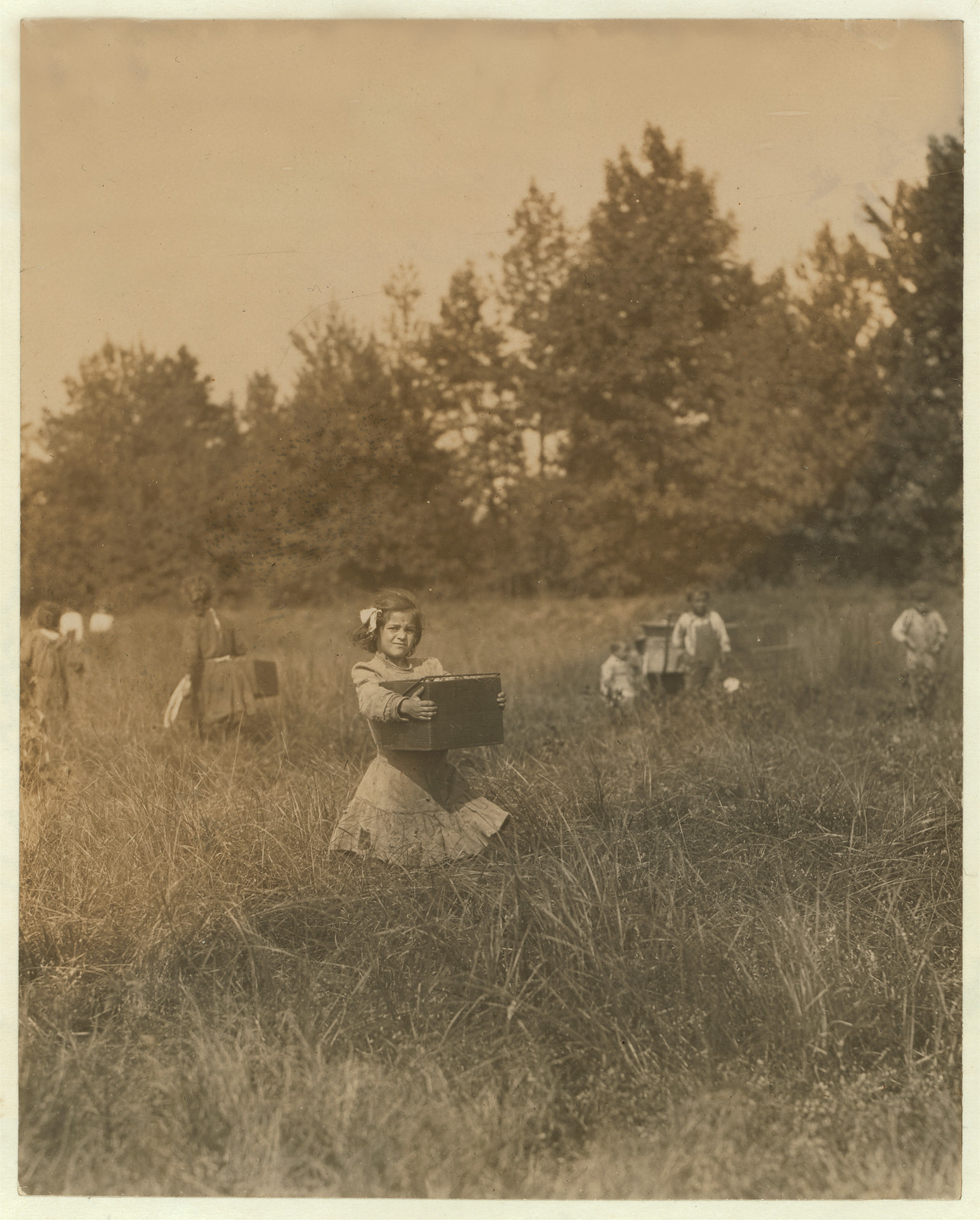 Tersea ------ carrying peck of cranberries (weighing about 15 pounds) long distance to "bushel man." Did not know age. Forsythe's Bog, Turkeytown, near Pemberton, N.J. Sept. 29, 1910 Witness E. F. Brown,. Location: Pemberton, New Jersey / Photo by Lewis W. Hine., 1910 September — historic image
