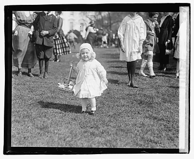 Toddler with Easter egg basket on a lawn