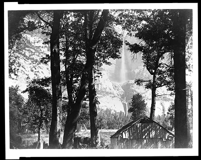 [Trees and cabin with Yosemite Falls in background, Yosemite National Park, Calif.]