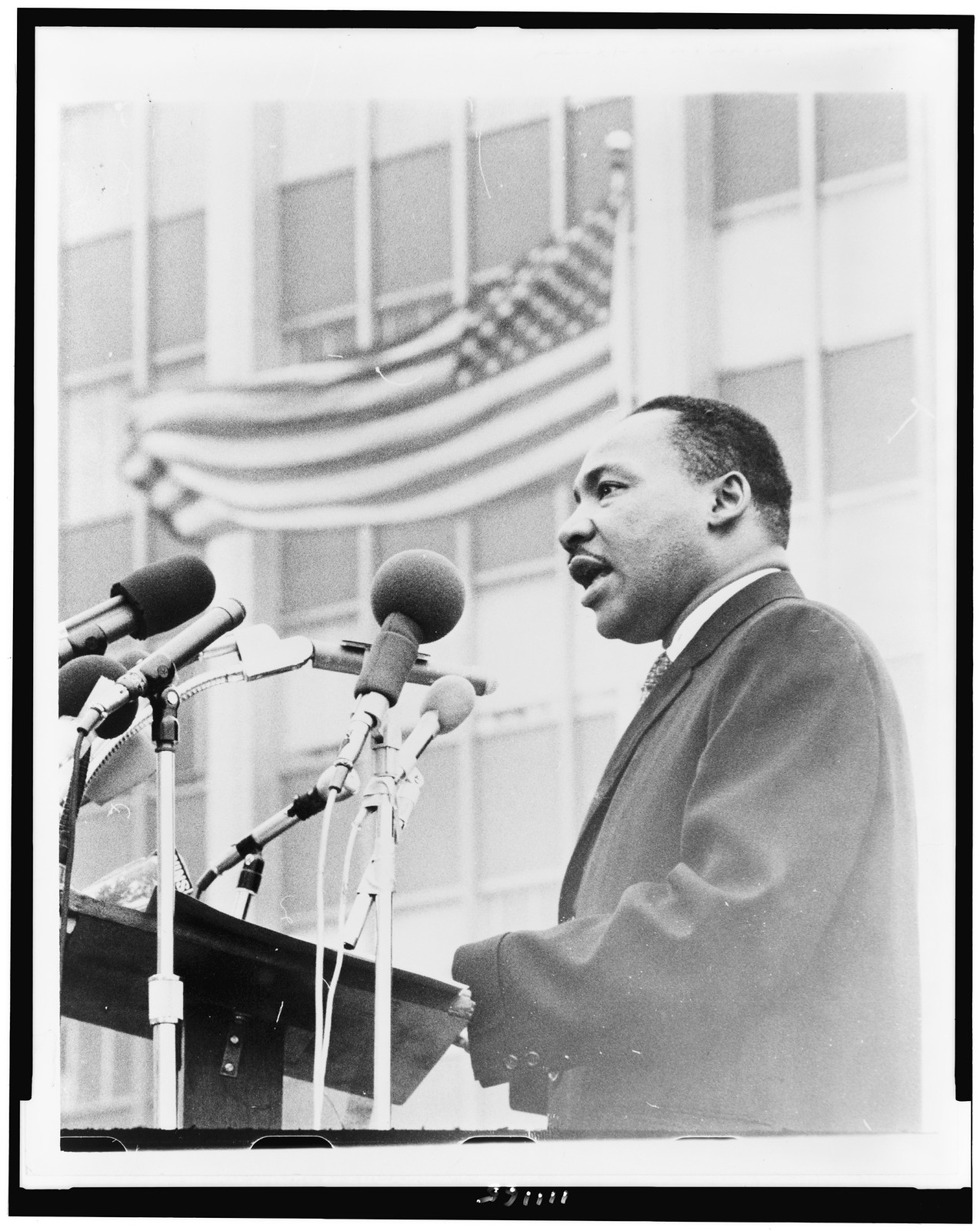 [Martin Luther King, Jr., half-length portrait, facing left, speaking at microphones, during anti-war demonstration, New York City] / World Journal Tribune photo by Don Rice. — historic photograph