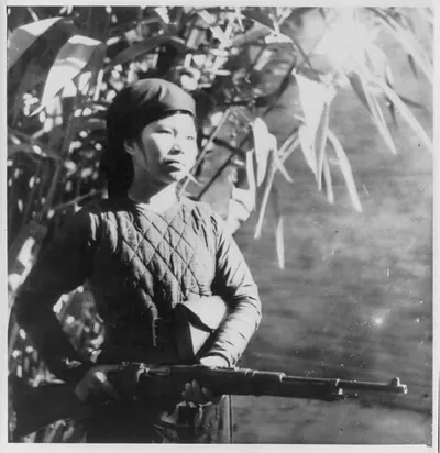 A [Vietnamese] woman-guerilla on guard duty